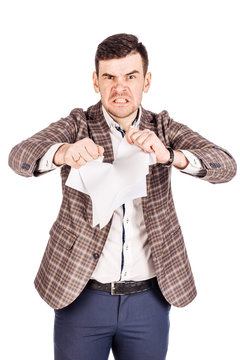 young businessman tearing paper in his hands on a white background.