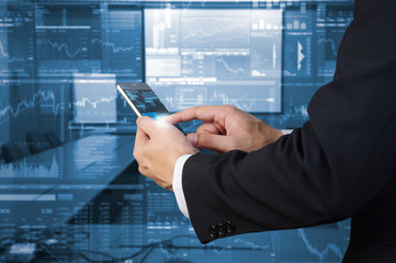 businessman using smart phone with investing background