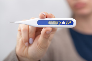 Sick women with a thermometer