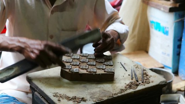 Craftsman making a wooden block for Block Printing for Textile in India. Mumbai, Maharashtra, India.