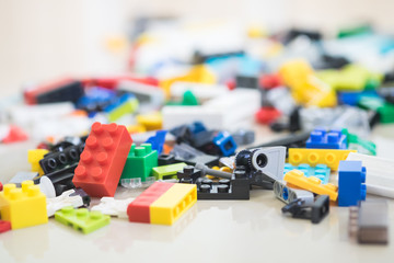 Obraz premium Missing piece of jigsaw puzzle among the pile of plastic blocks