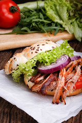 Pulled pork burger with coleslaw tomato, onion and fresh bread.