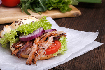 Pulled pork burger with coleslaw tomato, onion and fresh bread.