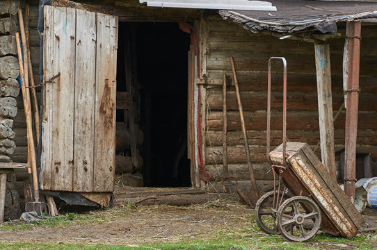 Old cart costs against a shed.