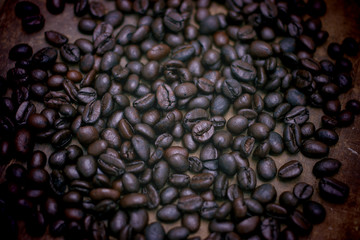 Coffee beans on wooden table.