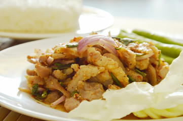 Thai spicy slice pork salad eat couple with sticky rice and fresh vegetable