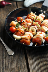 Vegetable and meat on wooden skewers on plate
