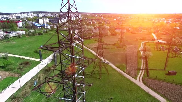 High voltage lines, electricity pylon at dawn filming from the air