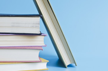 a stack of colorful books on a blue background