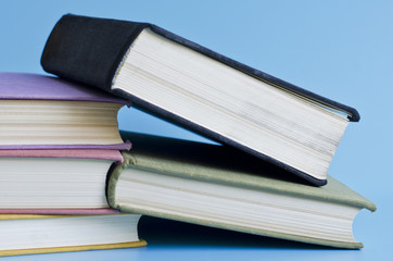 a stack of colorful books on a blue background