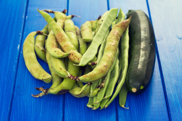 green fresh vegetables on blue wooden background