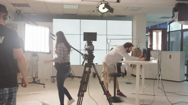  Time lapse of TV crew in studio, setting up for a shoot & packing away after.