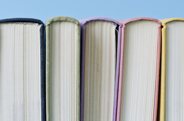 a stack of colorful books on a blue background