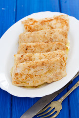 fried fish on white dish on wooden background