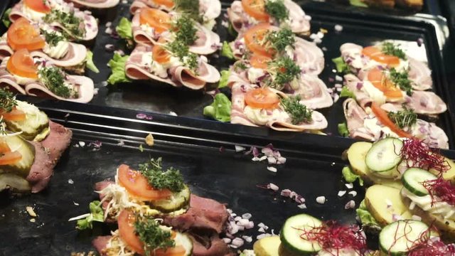 Denmark, scandinavian open sandwich. Delicious rye bread with different kind of meat, seafood, vegetable topping shot in slow motion 