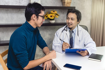 Fototapeta premium Asian male doctor discussing diagnosis with patient about his health in modern office of hospital, physician concept