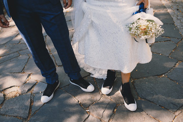 Fototapeta na wymiar Bride and groom's legs and shoes