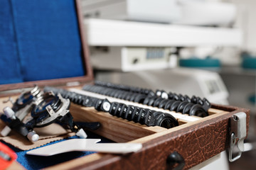 closeup of ophthalmic glasses for vision testing and set of lenses