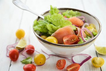 Lettuce salad with salmon and vegetables 
