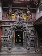 Fototapeta na wymiar Carved gate to the golden temple in Patan Kathmandu