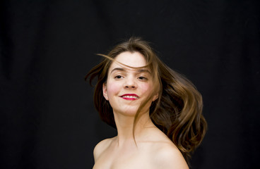 Fototapeta premium Portrait of Beautiful Young Woman Shaking Her Hair