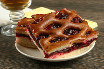 Homemade cherry pie on a wooden table.