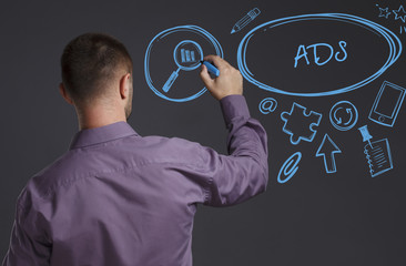 Business, Technology, Internet and network concept. A young businessman writes on the blackboard the word: ADS