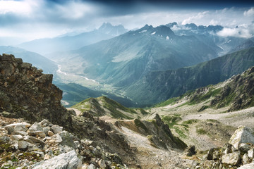 Fototapeta na wymiar Moraine on a glacier and snowy rocks in Caucasus