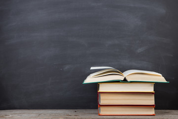 Education concept - books on the desk in the auditorium