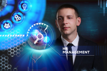 Business, Technology, Internet and network concept. Young businessman working on a virtual screen of the future and sees the inscription: HR management