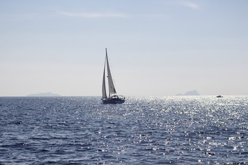 View of sailing boat near Istanbul. Sun light shines on Marmara sea surface.