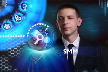 Business, Technology, Internet and network concept. Young businessman working on a virtual screen of the future and sees the inscription: SMM