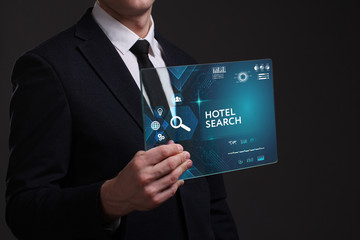 Business, Technology, Internet and network concept. Young businessman working on a virtual screen of the future and sees the inscription: Hotel search