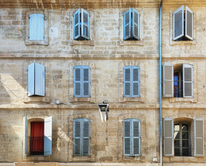 The facade of an old apartment building in the historic center of Avignon