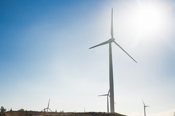 Wind turbine generating electricity with blue sky - energy conservation concept