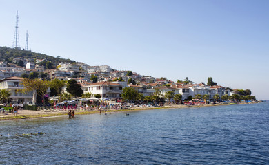 Fototapeta premium View of beach in Kinaliada which is one of Prince Islands also known as Adalar in Istanbul. Summer houses and people taking sun bath are in the view. It is the closest one to Istanbul