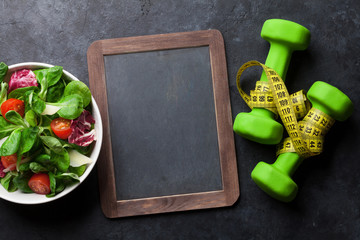 Healthy salad and fitness equipment