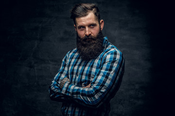 Bearded male with crossed arms, dressed in a blue fleece shirt.