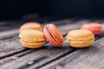 Delicious, colorful cookies on a grey wooden table.