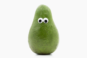 avocado with googly eyes on white background © jack1986