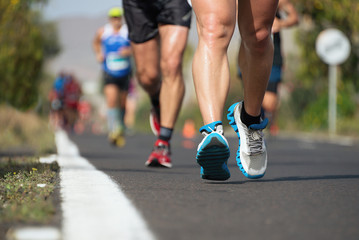 Fototapeta premium Marathon running race, people feet on city road