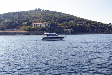 Small yacht passes by Haybeliada which is one of Prince Islands in Istanbul.
