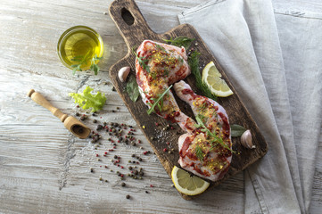 chicken legs in marinade with olive oil. 