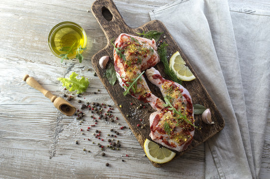 chicken legs in marinade with olive oil. 