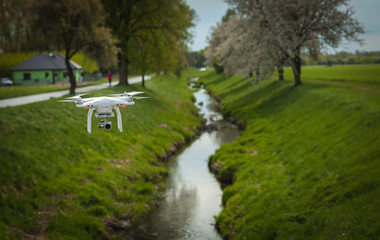 Drone flying over a field next to the village and shooting spring nature