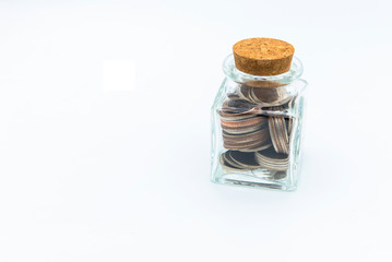 bottle of coins, with blank paper tag on white background business  financial concept