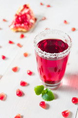 Pomegranate drink in glass with sugar decoration