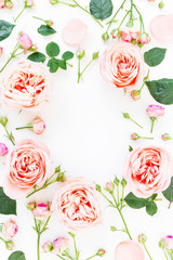 Round frame made of peony roses and buds isolated on white background. Flat lay, top view. Floral background.
