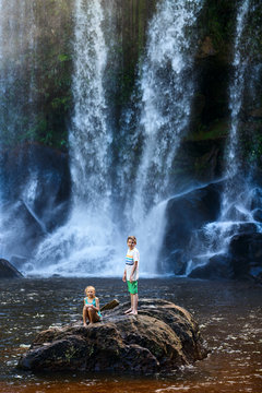 Kids swimming in waterfall