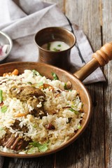 Kerala Malabar Mutton Biryani served with yogurt dip, selective focus